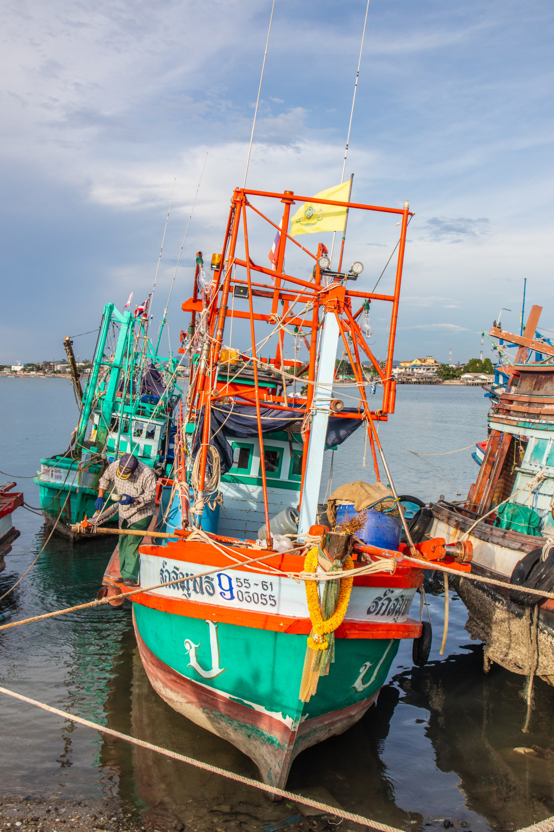 "Thai fishing boats at a pier or wharf in Thailand Southeast Asia" stock image