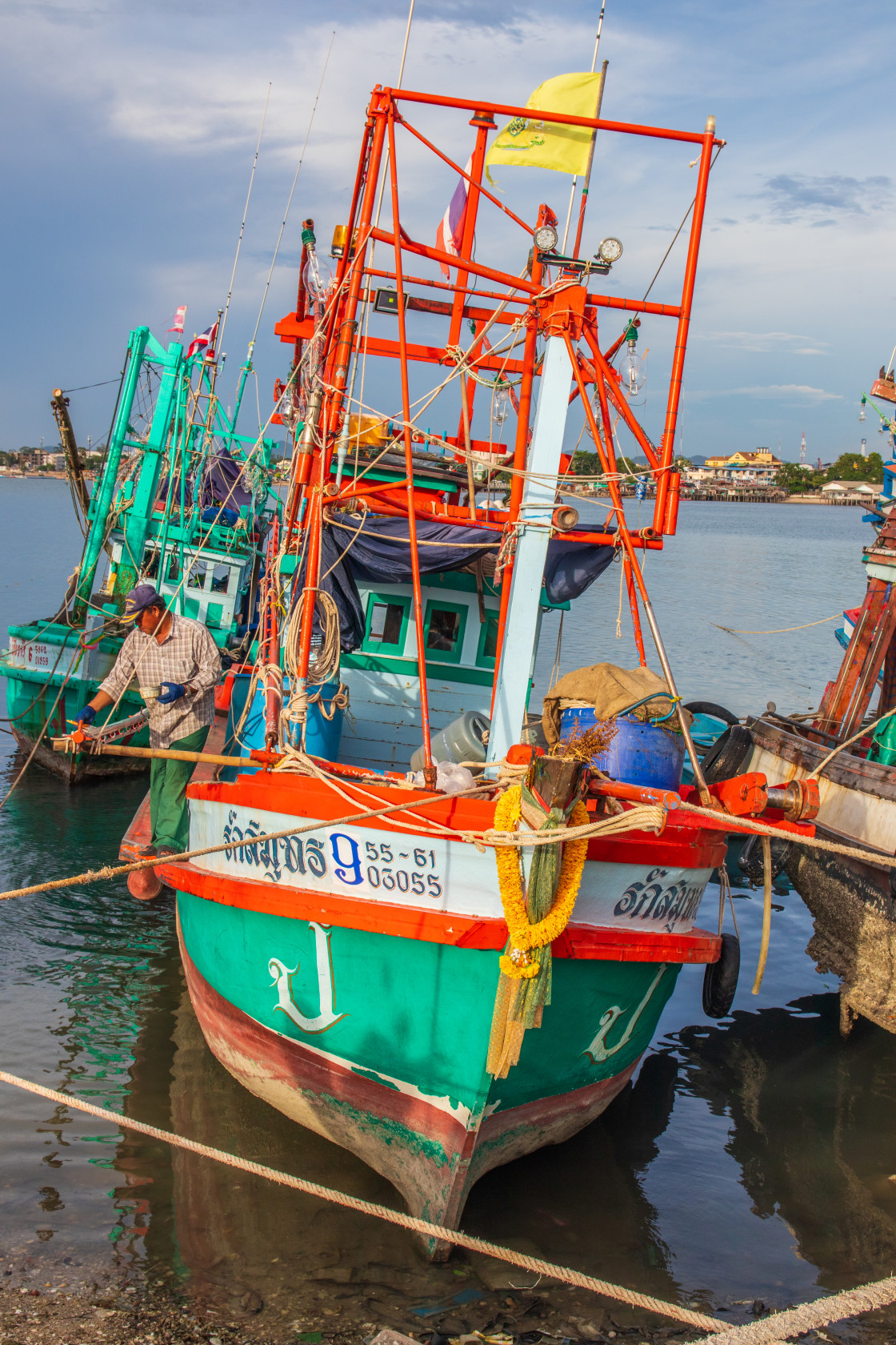 "Thai fishing boats at a pier or wharf in Thailand Southeast Asia" stock image