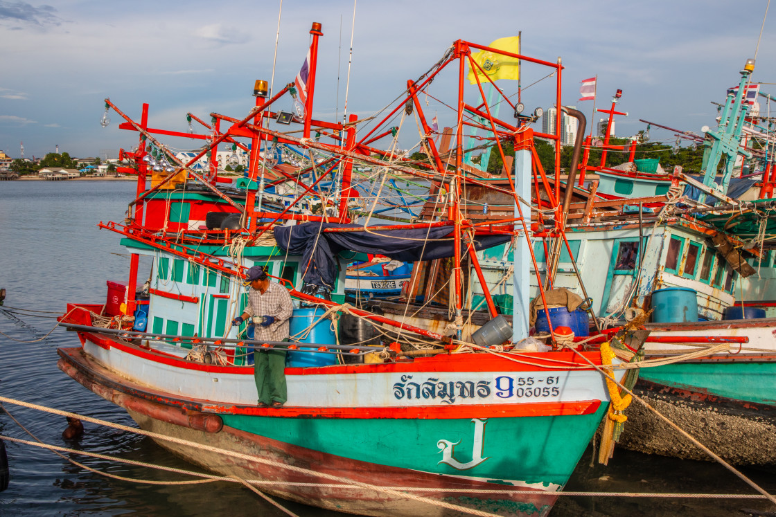 "Thai fishing boats at a pier or wharf in Thailand Southeast Asia" stock image