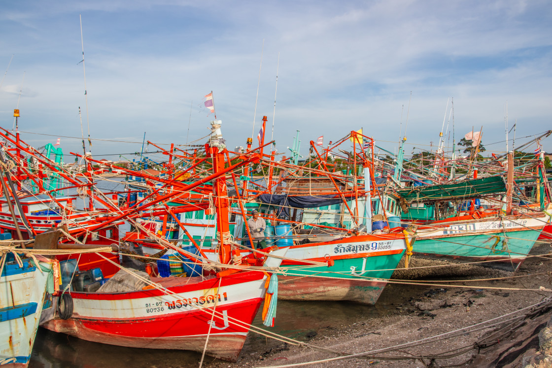 "Thai fishing boats at a pier or wharf in Thailand Southeast Asia" stock image