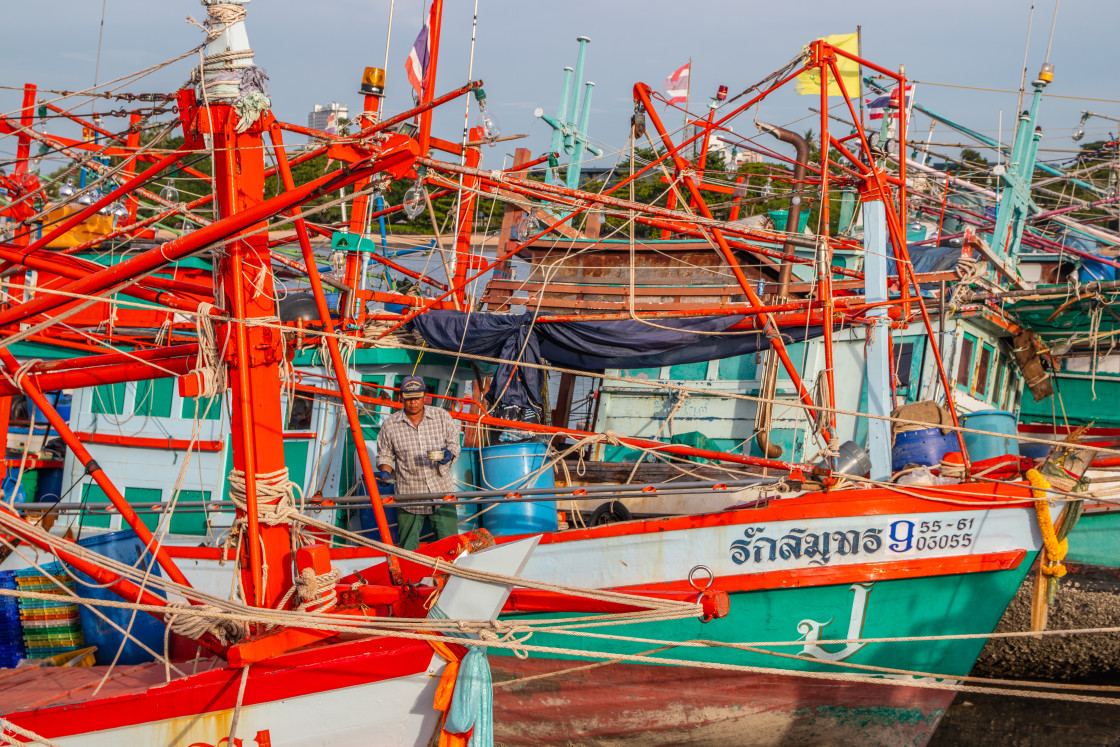 "Thai fishing boats at a pier or wharf in Thailand Southeast Asia" stock image