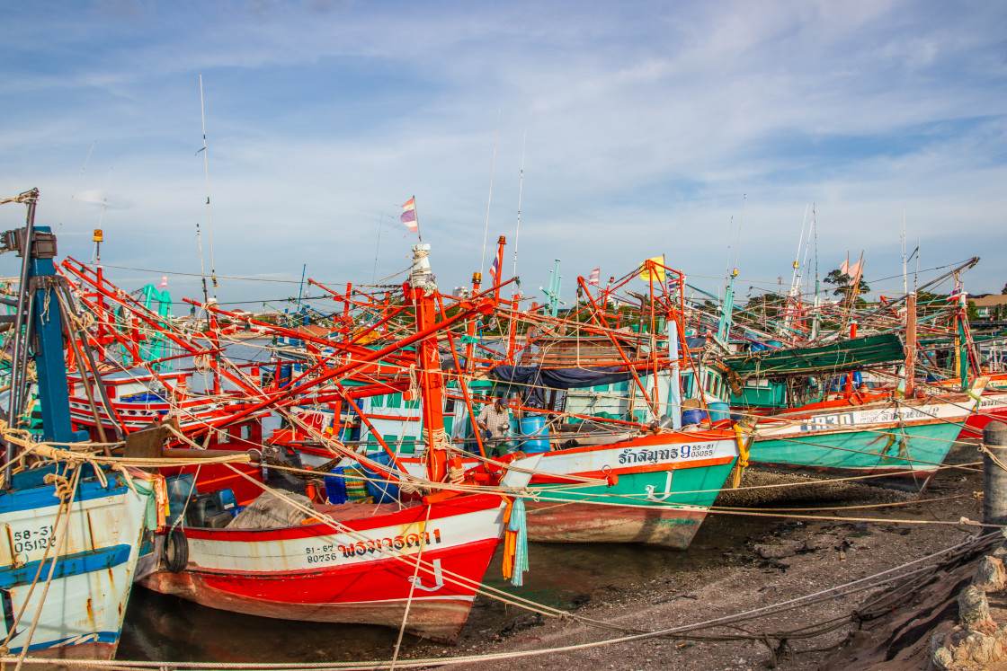 "Thai fishing boats at a pier or wharf in Thailand Southeast Asia" stock image