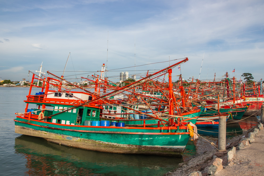 "Thai fishing boats at a pier or wharf in Thailand Southeast Asia" stock image