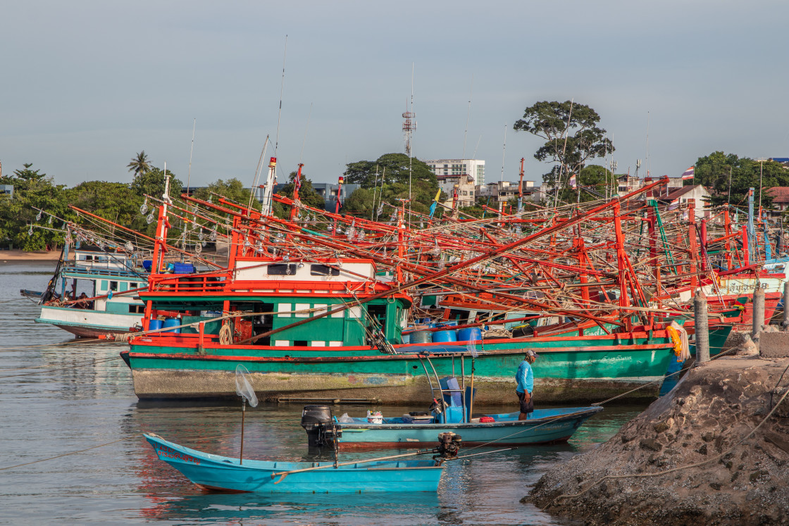 "Thai fishing boats at a pier or wharf in Thailand Southeast Asia" stock image