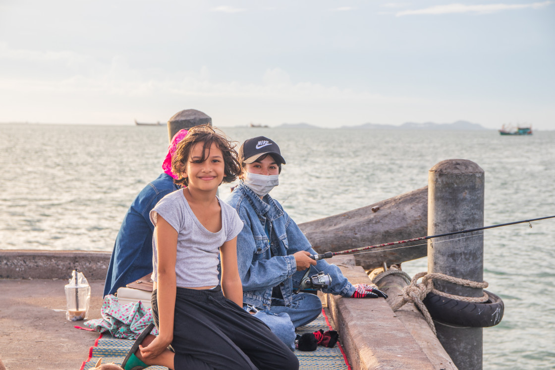 "A Thai family fishing at a pier in Naklua Thailand Southeast Asia" stock image