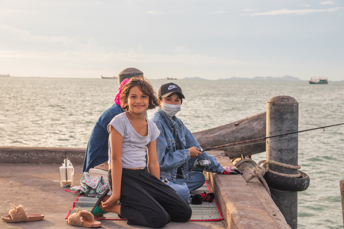 "A Thai family fishing at a pier in Naklua Thailand Southeast Asia" stock image