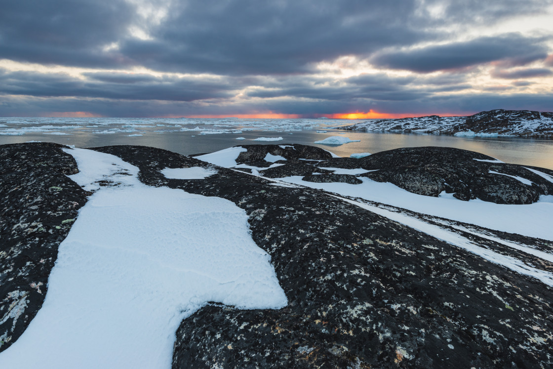 "Sunset at coastal landscape with icebergs in fjord" stock image