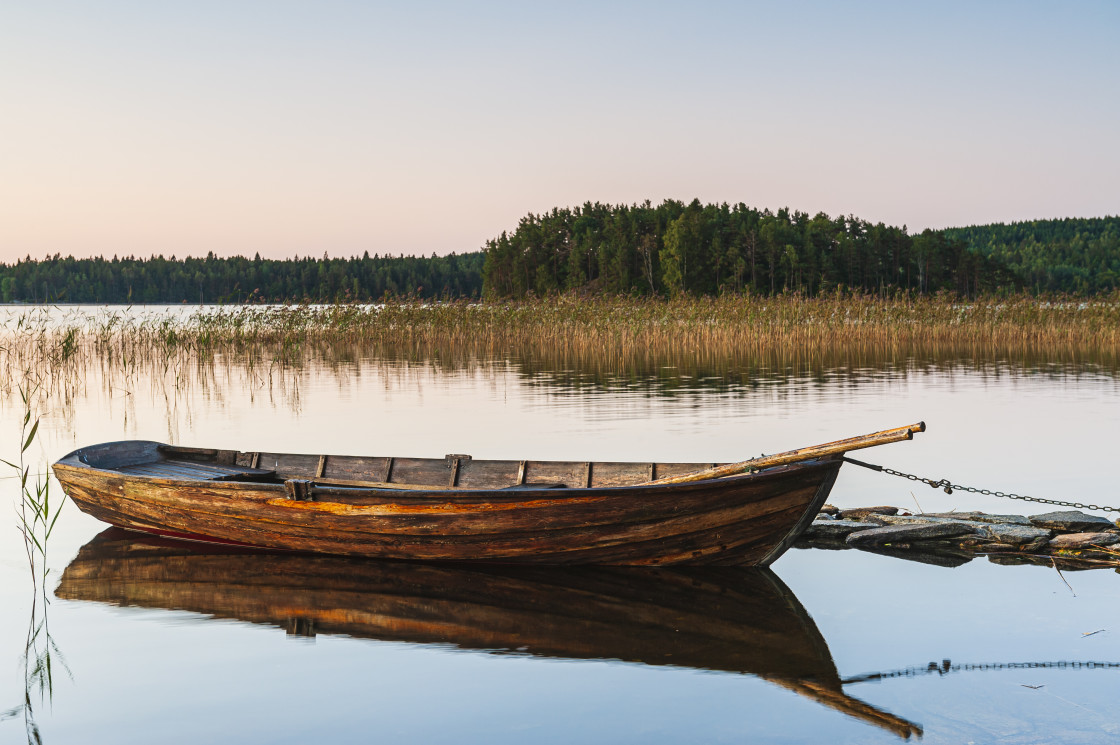 "Wooden boat on still lake" stock image