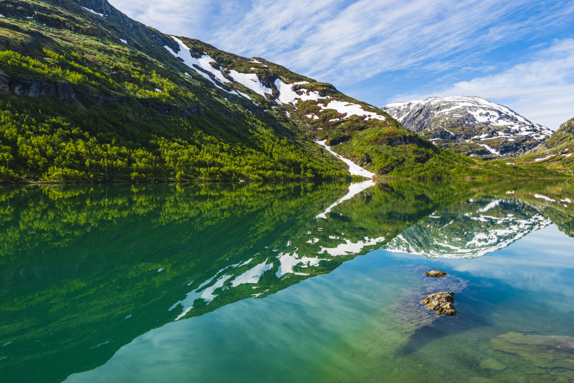 "Reflection of still mountain lake" stock image