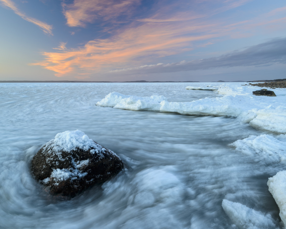 "Frozen shore along the coast of Näsbokrok Nature reserve at sunset, Halland,..." stock image