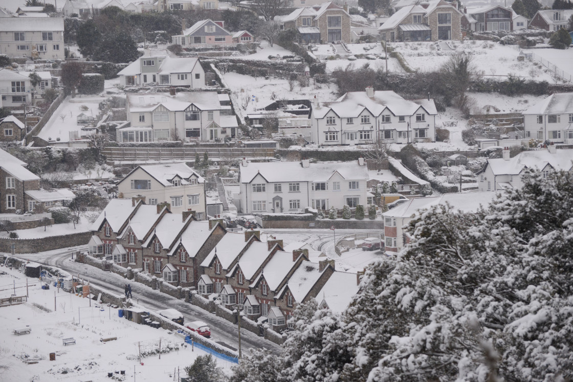 "Looking out across a snow covered village" stock image