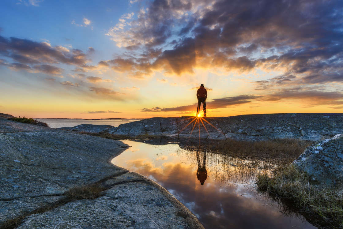 "Man standing and viewing sunset" stock image