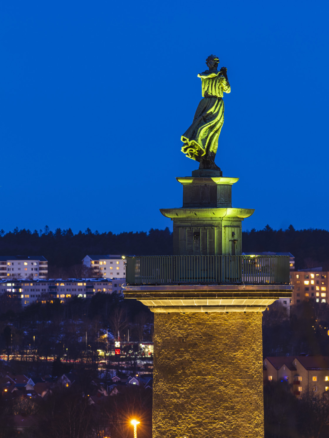 "Illuminated bronze statue of a woman" stock image