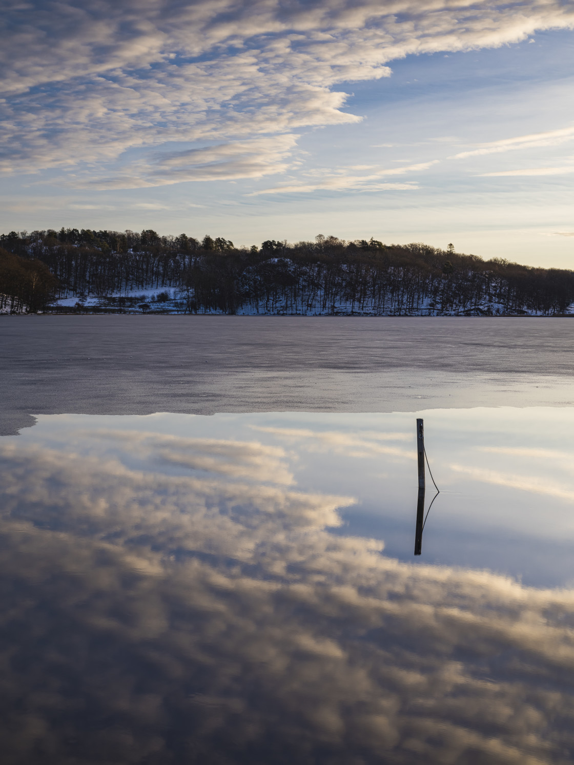 "A peaceful winter landscape in Sweden, reflecting a morning sky of tranquil..." stock image