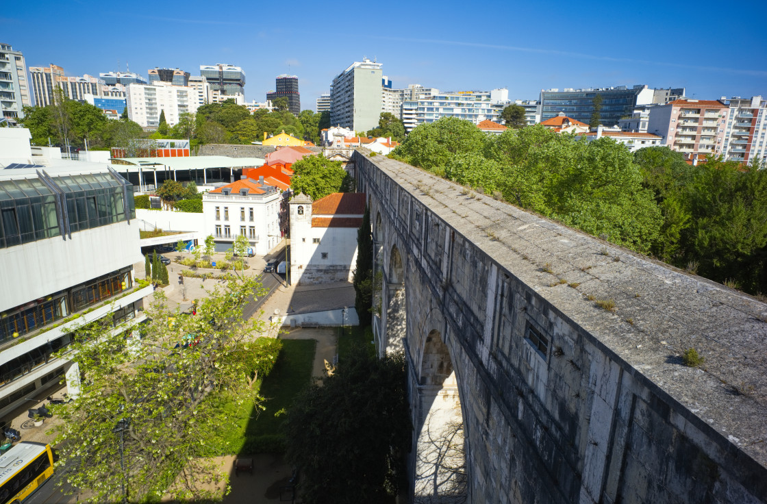 "Looking along the aqueduct at Amoreiris, Lisbon with high rise buildings behind" stock image