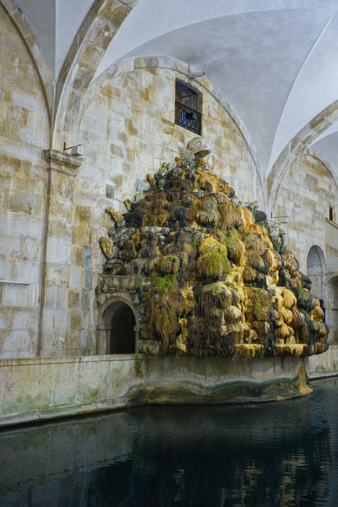 "The mineral and weed encrusted water entry point from the aqueduct at the museum of water, Lisbon" stock image