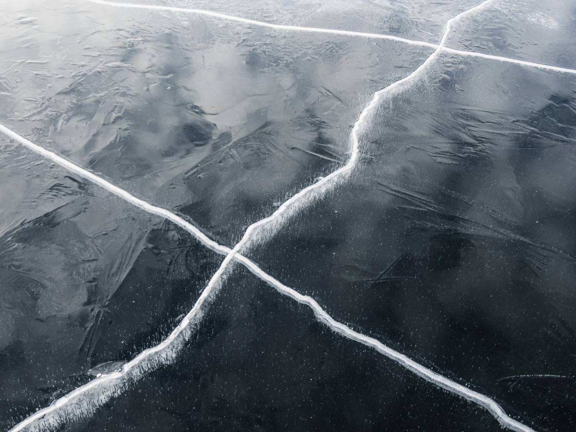 "Crystalline Patterns of Frozen Lake Ice Under Winter Sunlight" stock image