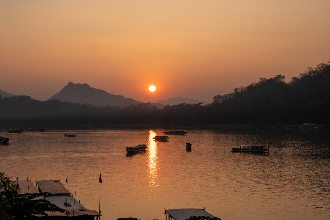 "Wooden Boats at the Mekong River of Luang Prabang in Laos Southeast Asia during the Sunset Time" stock image
