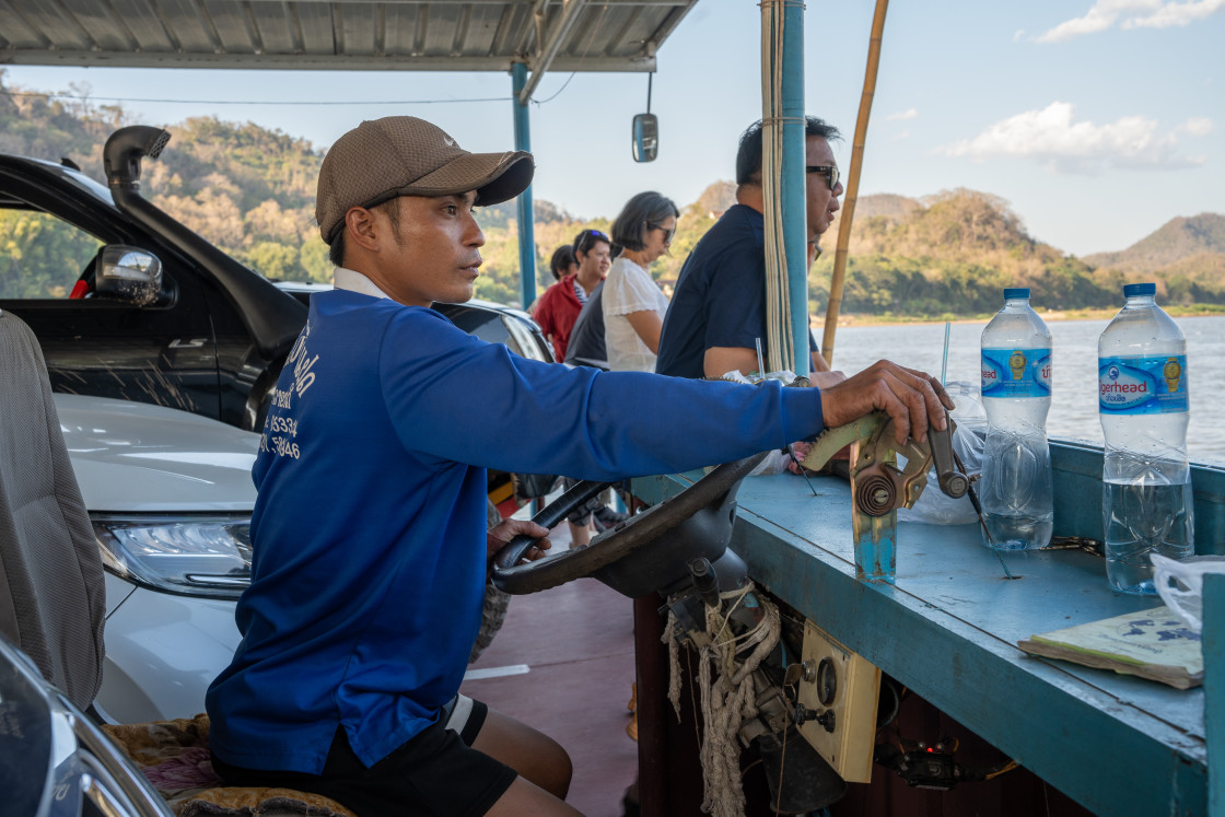 "A helmsman at the control desk of a ferry on the Mekong River in Luang Prabang Asia" stock image