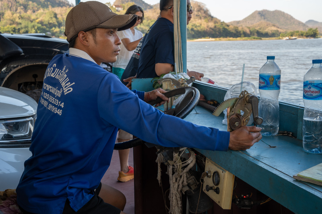 "A helmsman at the control desk of a ferry on the Mekong River in Luang Prabang Asia" stock image