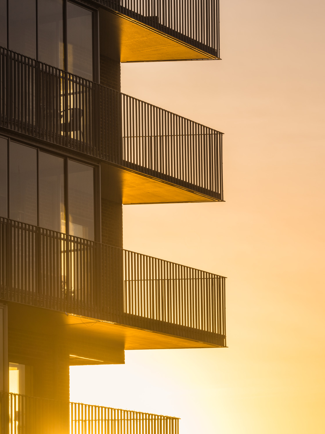 "Golden Sunrise Illuminating Balconies of a Modern Building in Gothenburg, Sweden" stock image