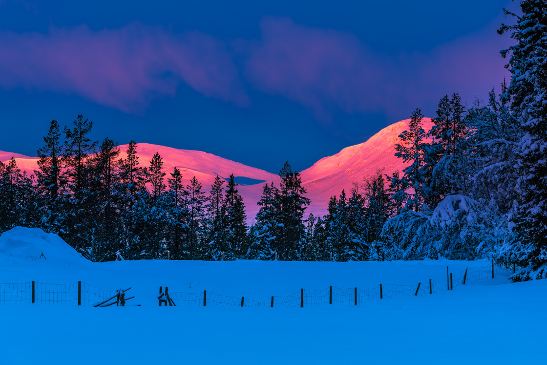 "Serene Sunrise Over Snow-Capped Swedish Mountain With Foreground Fence" stock image