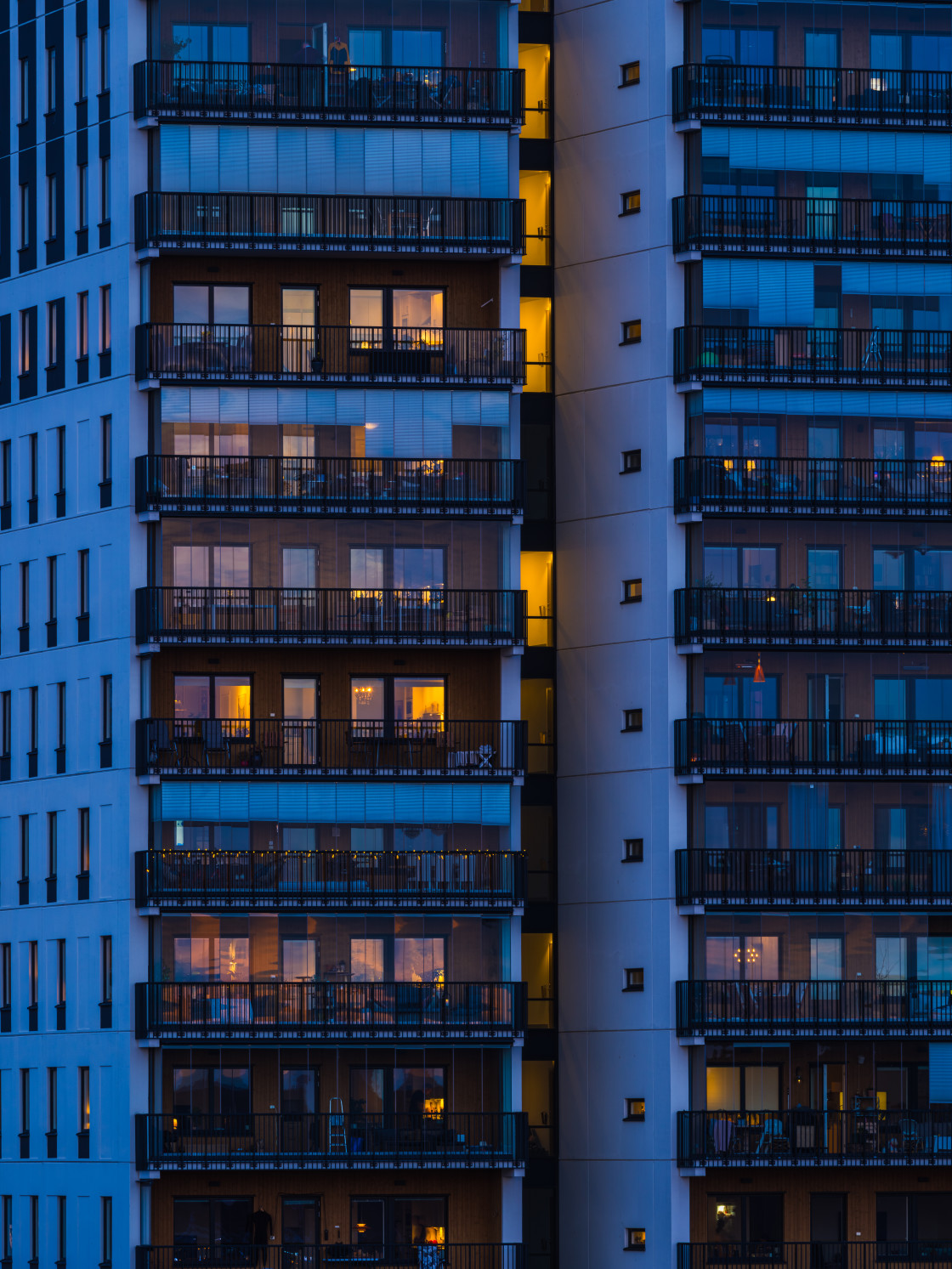 "Illuminated Tall Building With Balconies at Night" stock image