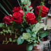 Media 4 - 7 Red Roses with greenery