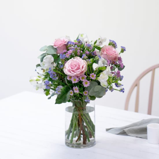 Bouquet of roses and mixed flowers with decorative greenery