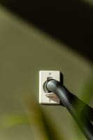 Close-up of a central vacuum hose connected to a Flexit wall inlet valve