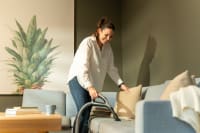 Vacuuming a sofa using a Flexit central vacuum hose set