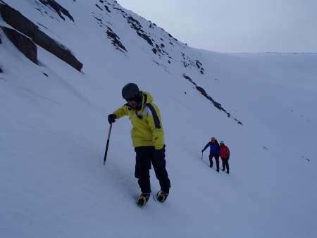 Using ice axe and crampons