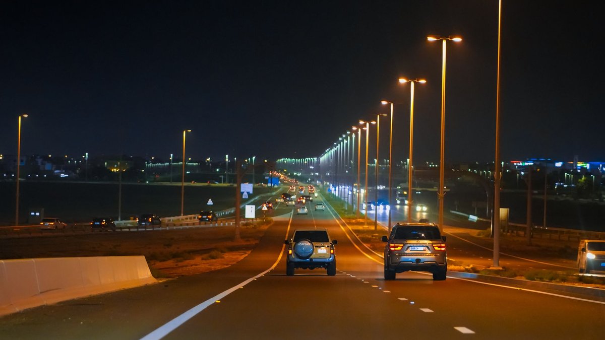 Aldar Unveils Saadiyat Grove Retail Complex Illuminated highway in Abu Dhabi with cars and streetlights at night.