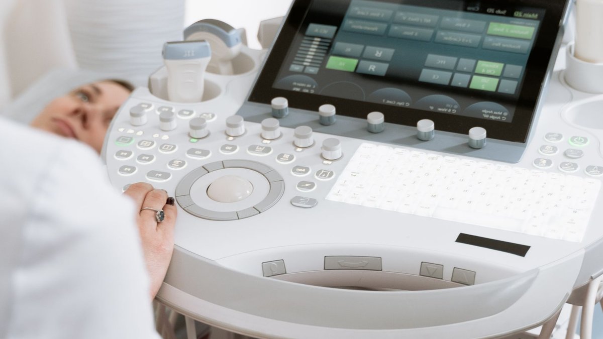 Close-up of a professional conducting an ultrasound examination in a modern medical clinic.