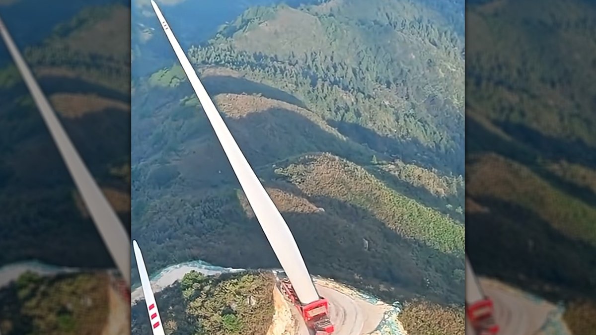 Giant wind turbine blade transported up treacherous Chinese mountain road - wind turbine blade transport