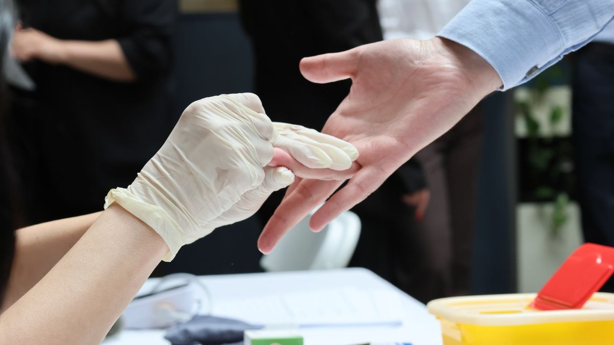 Medical professional wears gloves for a healthcare procedure. Safety and hygiene in medical settings.