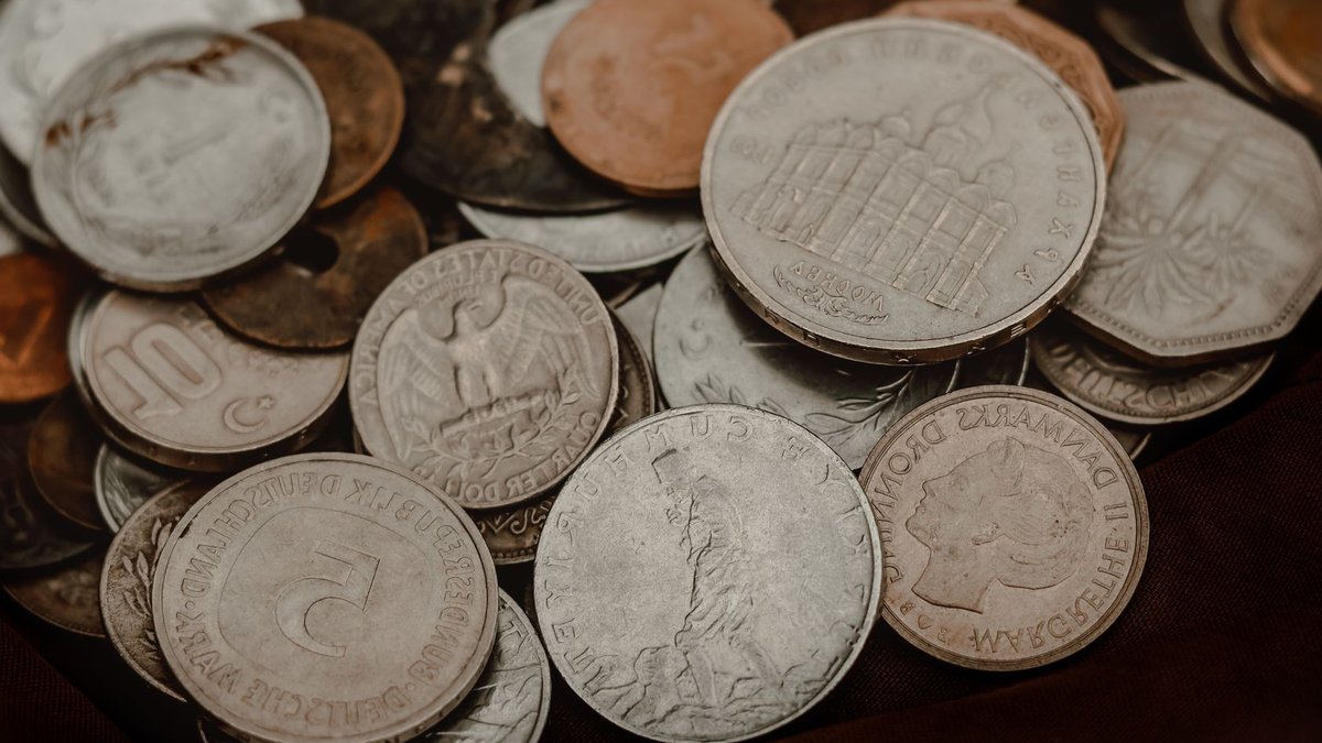 Collection of various vintage coins showcasing global currency diversity.