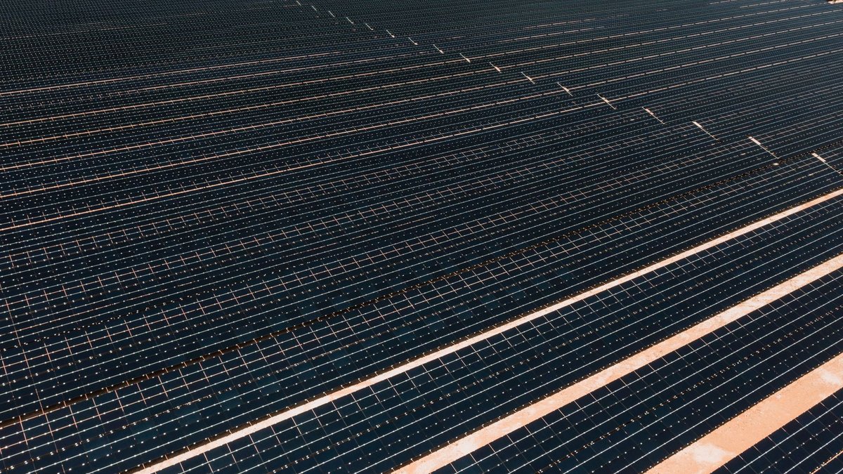 AI can improve sustainability reporting reliability A vast array of solar panels in a solar farm, illustrating renewable energy and sustainability.