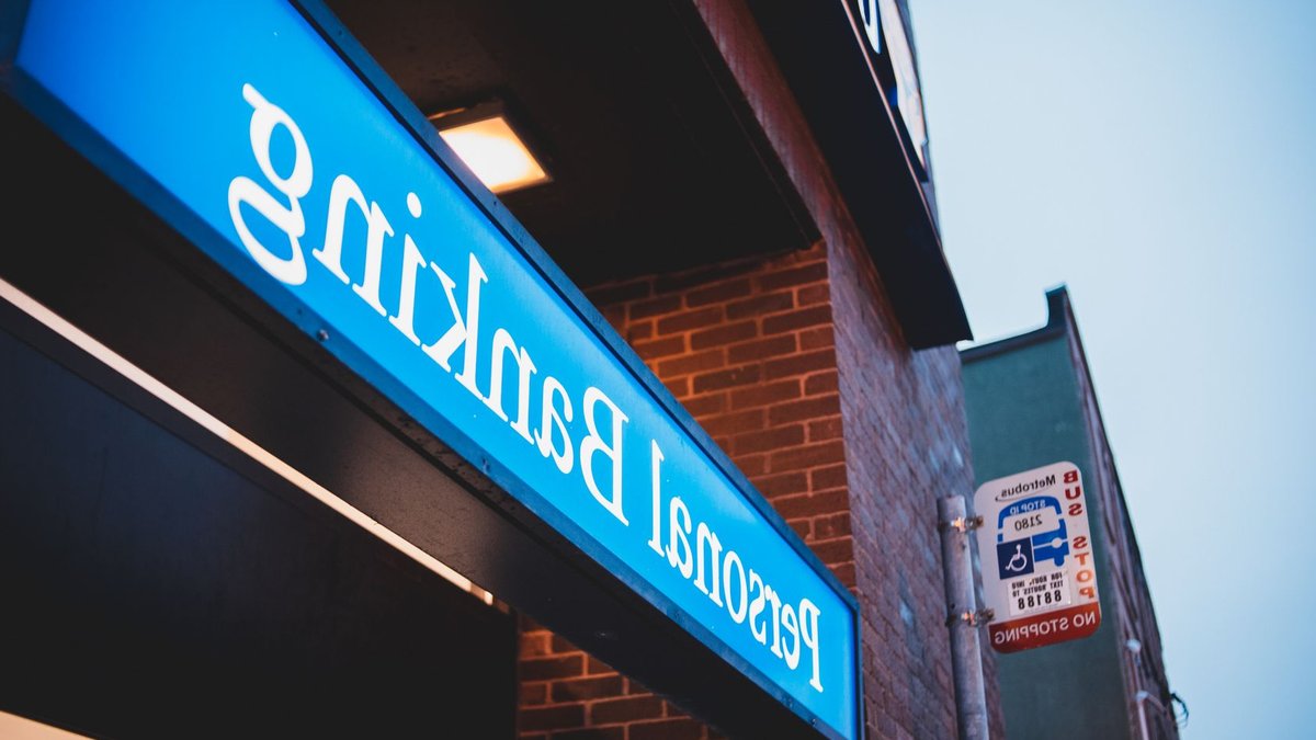 Citi Intuit Robinhood Launch New Financial Tools From below of bright blue signboard saying personal banking on modern building of town.