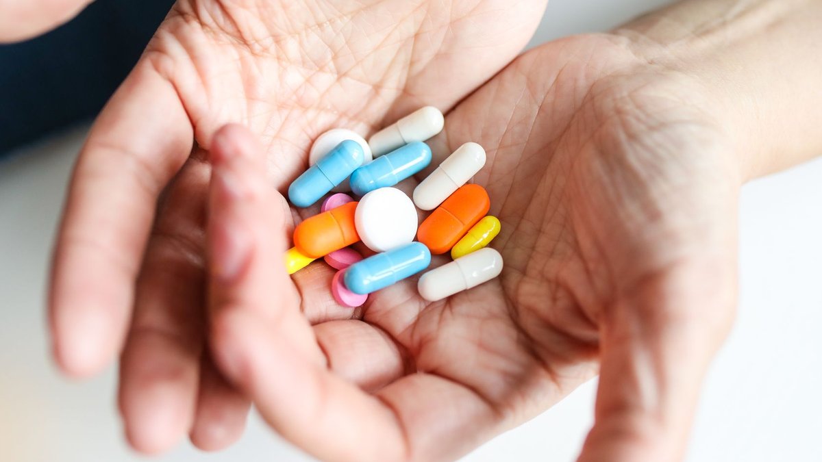 ER Visits by Immigrants Drop After ICE Raids Assorted colorful pills and capsules in hands, representing healthcare treatment.