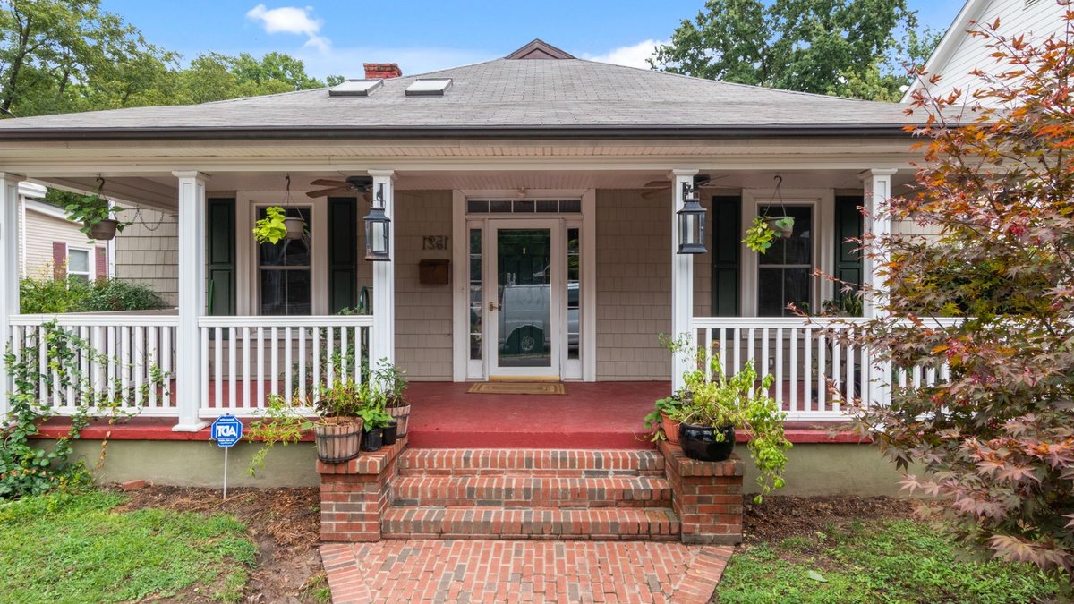 Saskatchewan listings rise, giving buyers more options Inviting suburban house with a classic porch and lush garden, perfect for real estate listings.