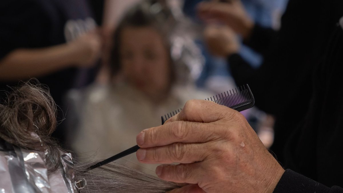 Nu-Hair offers complete hair care range Hair salon scene with a hairdresser using foil and comb for highlights.