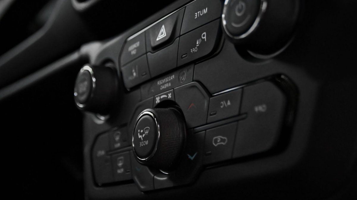 Detailed close-up of a car's control panel featuring various buttons and switches for functionality.