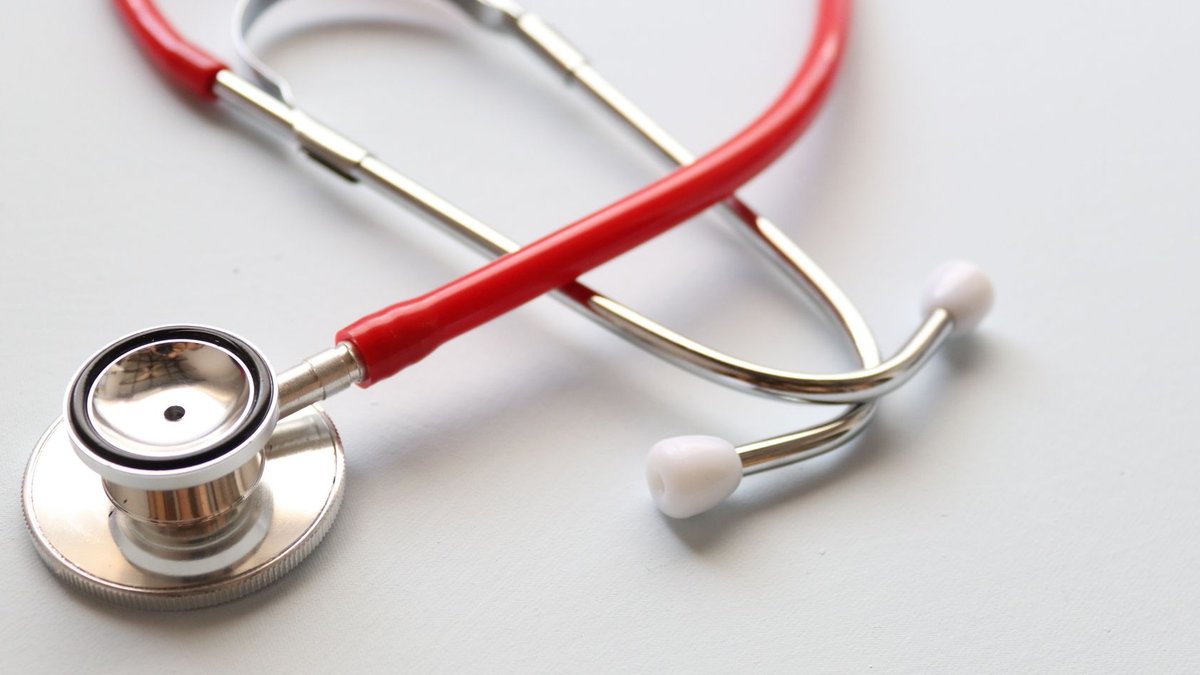 Close-up of a red stethoscope symbolizing medical care and healthcare diagnostics.