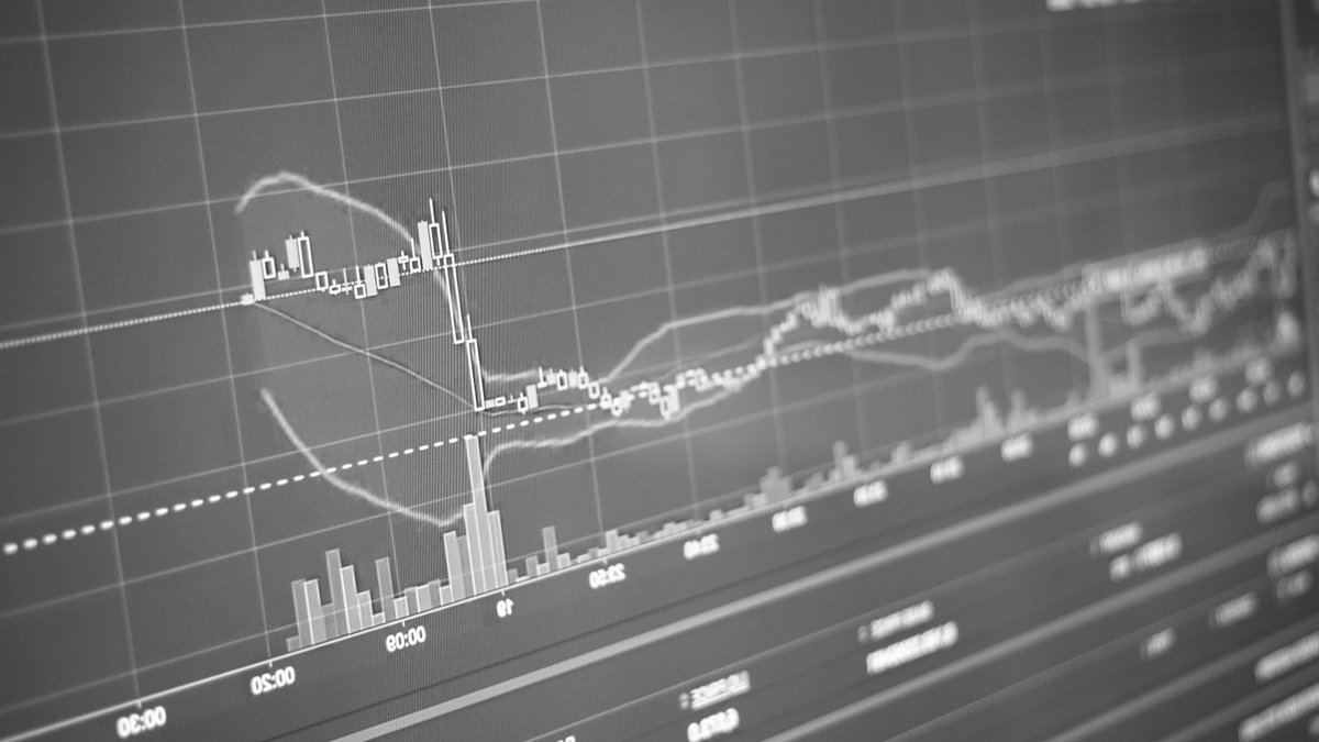 Investors again underestimate market risks Black and white display of financial chart with data and statistics for trading analysis.