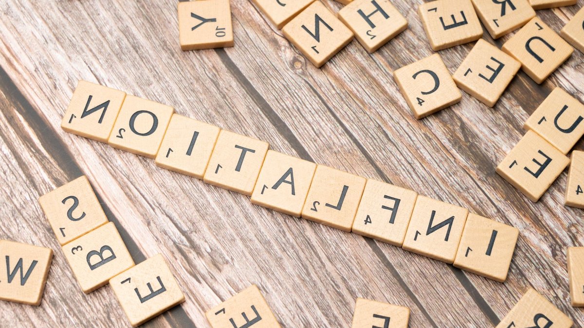 Ireland’s economy to grow despite inflation pressures Wooden letter tiles forming the word 'inflation' on a rustic wooden surface, symbolizing economic themes.