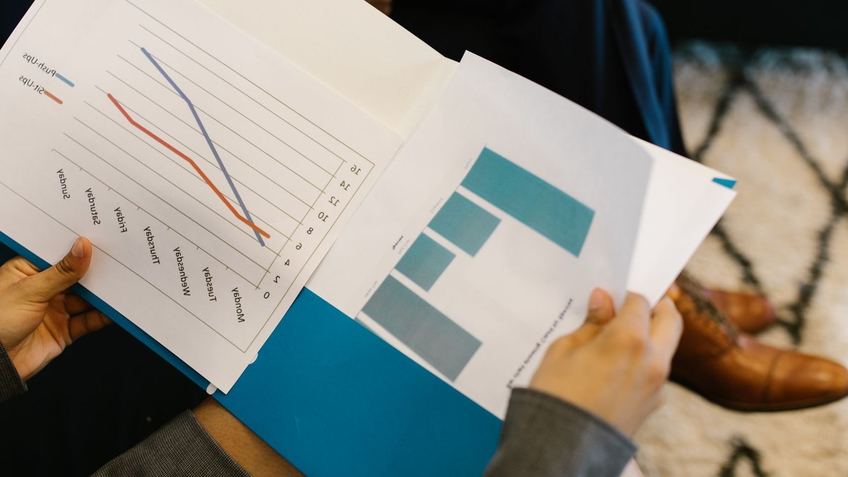 Detailed view of business reports with graphs during a corporate meeting.