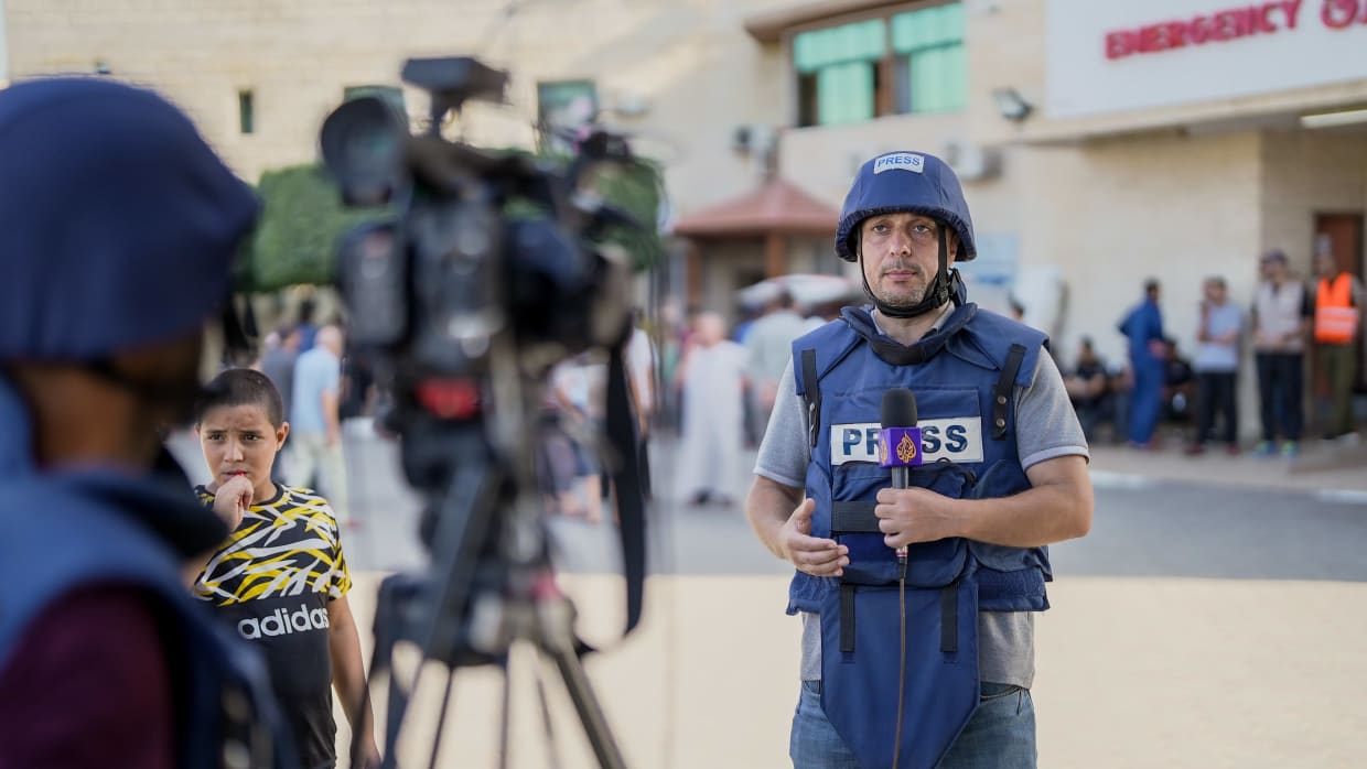 Al Jazeera journalist Hisham Zaqout broadcasts in front of hospital in Gaza