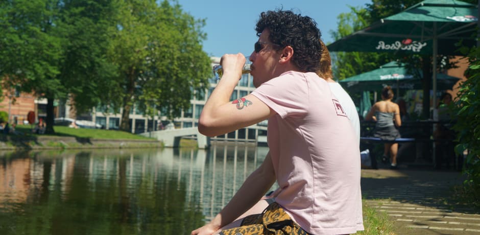 Na een lange studiedag wordt zichtbaar genoten van een koud biertje.
