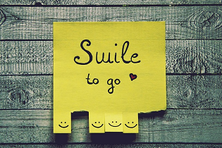 A sticky pad with "smile to go" written on it